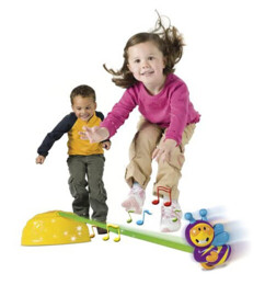Enfants jouant avec jouet Playskool Hop Hop l'Abeille : base jaune, piste verte et abeille violet en situation