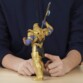 Figurine Thanos vue de dos avec gant de l’infini, mains d’une personne encadrant le personnage